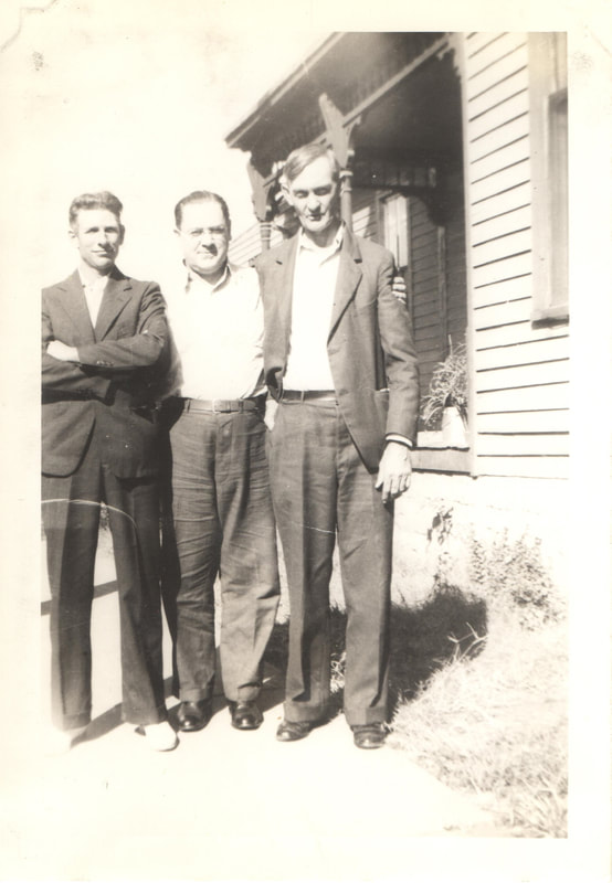 Men standing next to house