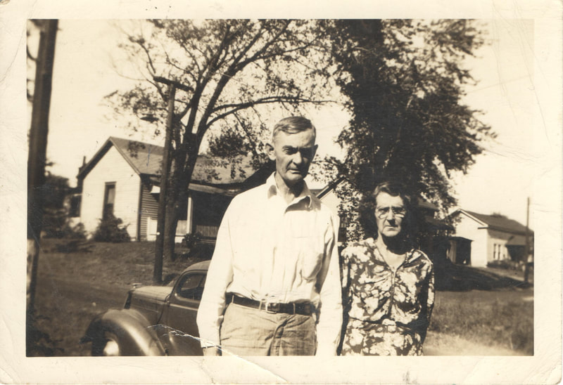 Couple standing in front of car