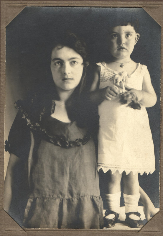 Young woman standing next to young girl on table