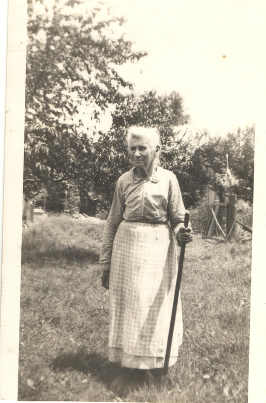 Elderly woman holding walking stick