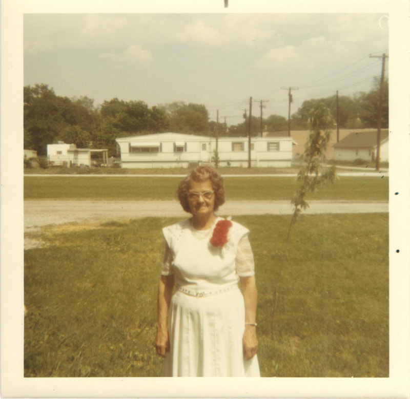Woman wearing white dress with pinned flowers