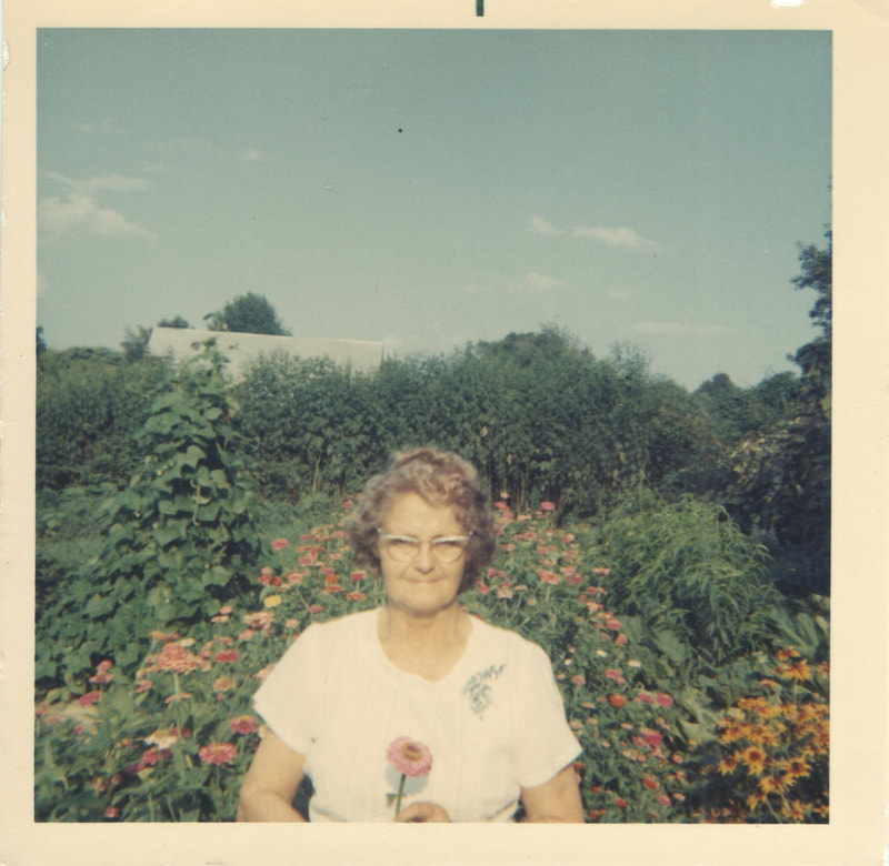 Woman holding flower in garden
