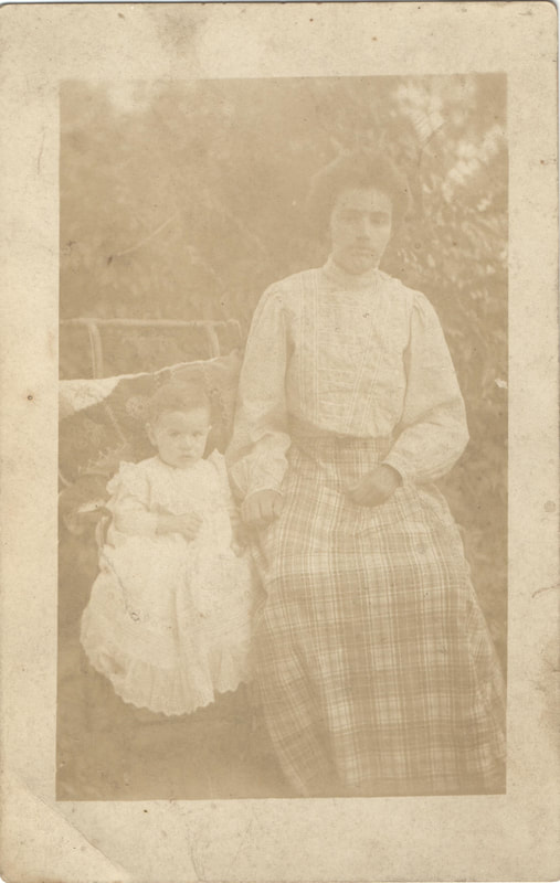 Young woman seated next to baby