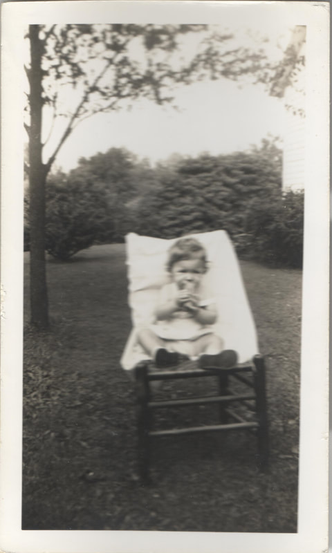 Young girl seated in chair