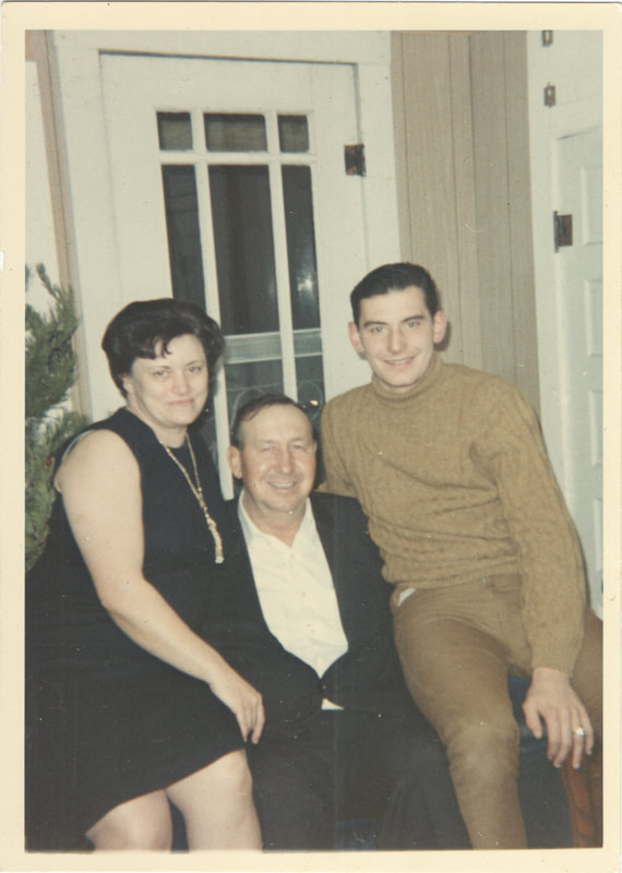 Young man seated next to parents in home