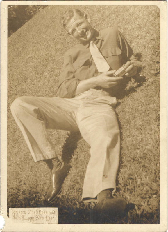 Soldier wearing tie lying on grass