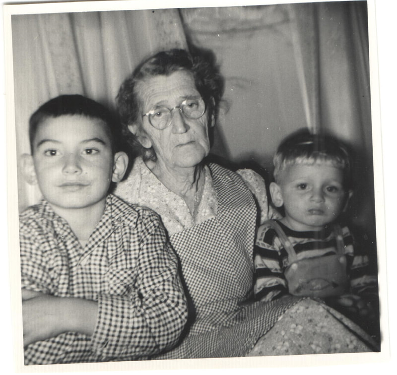 Elderly woman seated with young boys