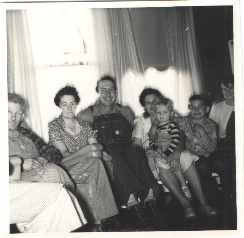 Family gathered seated on couch in home