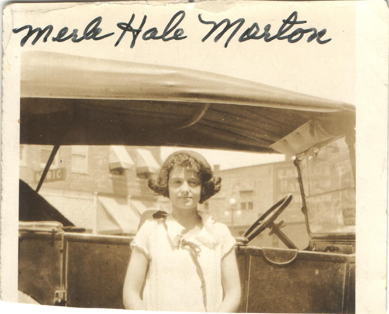 Young woman standing in front of car