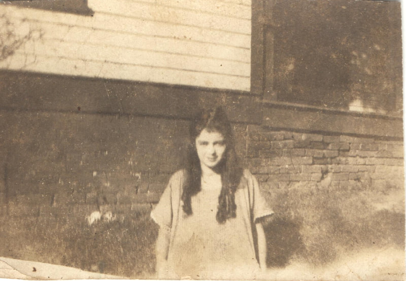 Young woman standing in front of building 