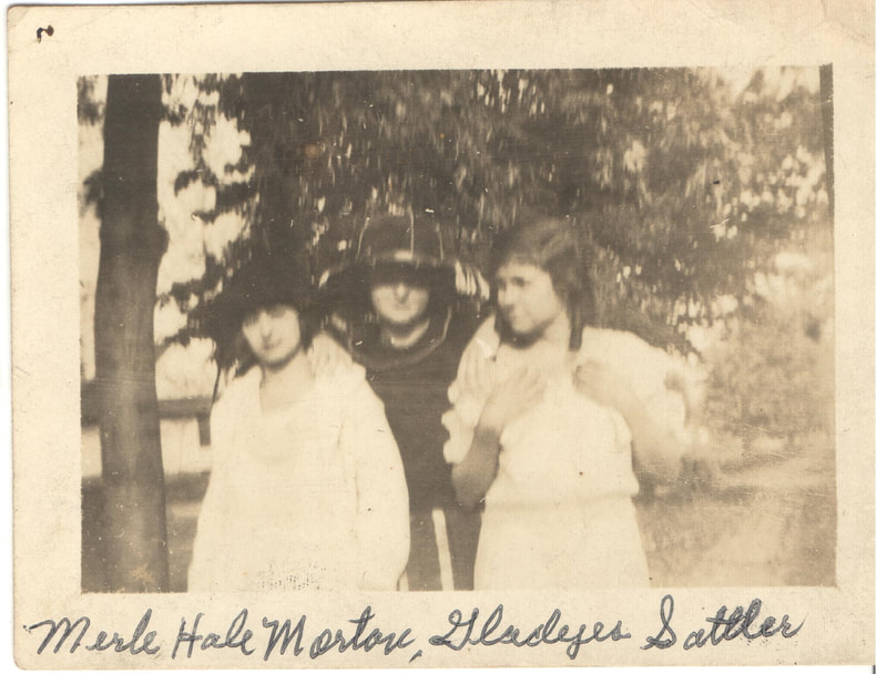 Young women with hats standing together