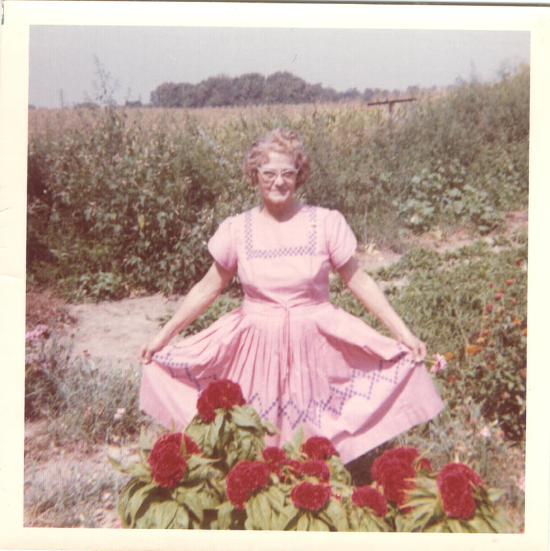 Woman fanning dress in flower garden
