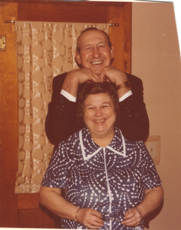 Man resting elbows on shoulders of woman
