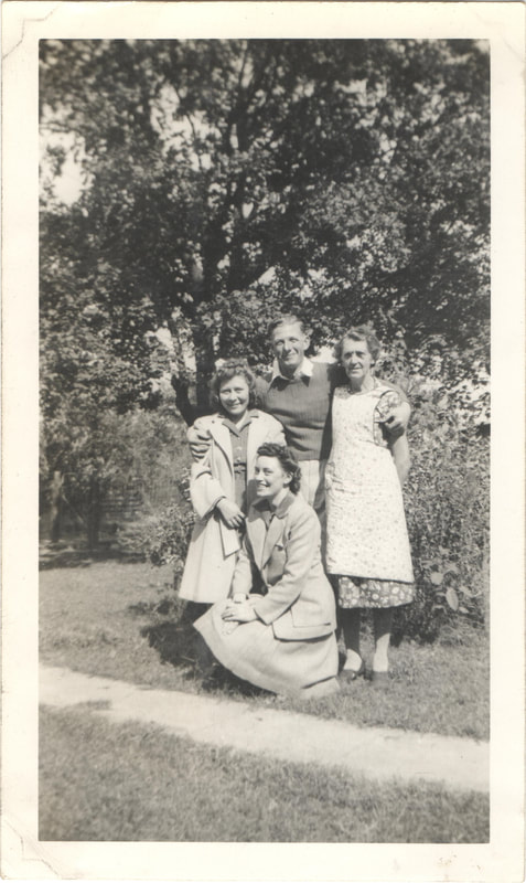Man with arms around women standing together in yard