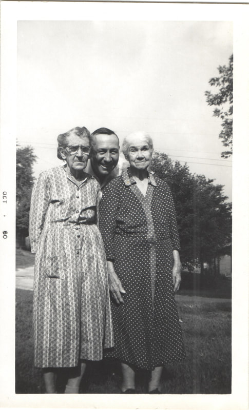 Elderly women standing in front of man