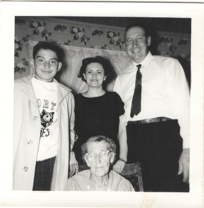 Family standing behind seated elderly woman