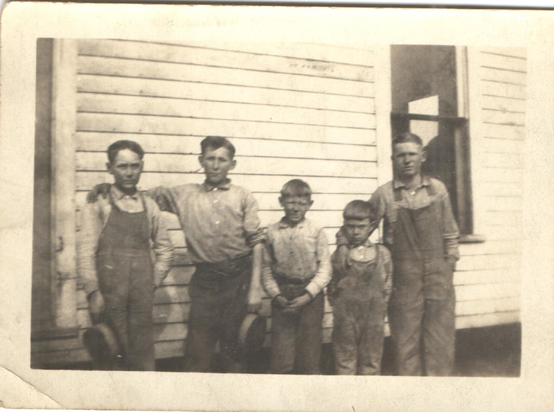 Young boys standing in front of house