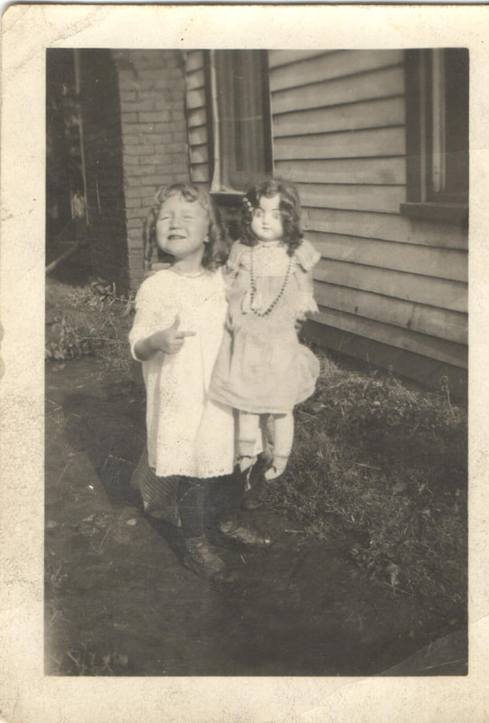 Young girl holding doll