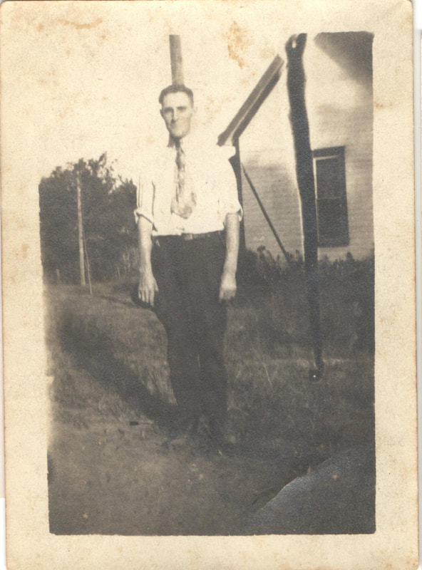 Man in tie standing in yard