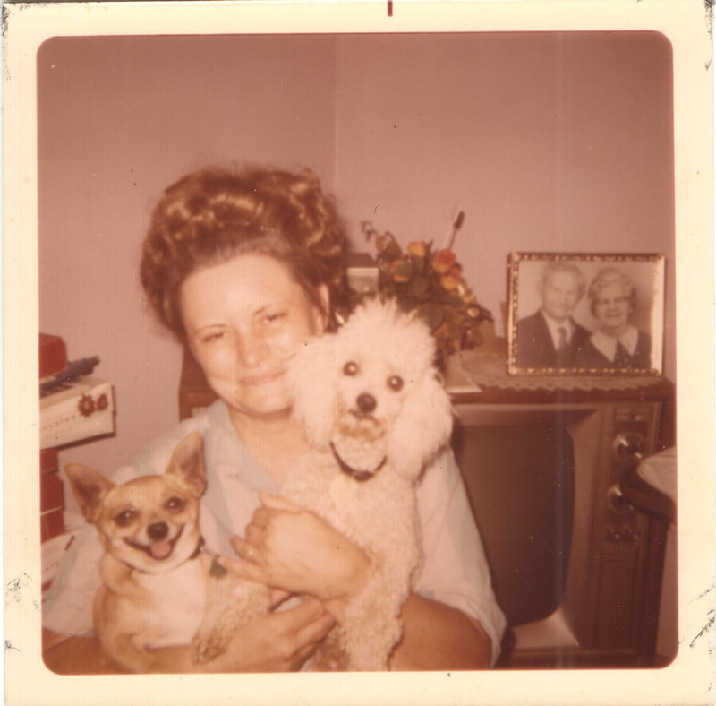 Woman holding dogs inside of house