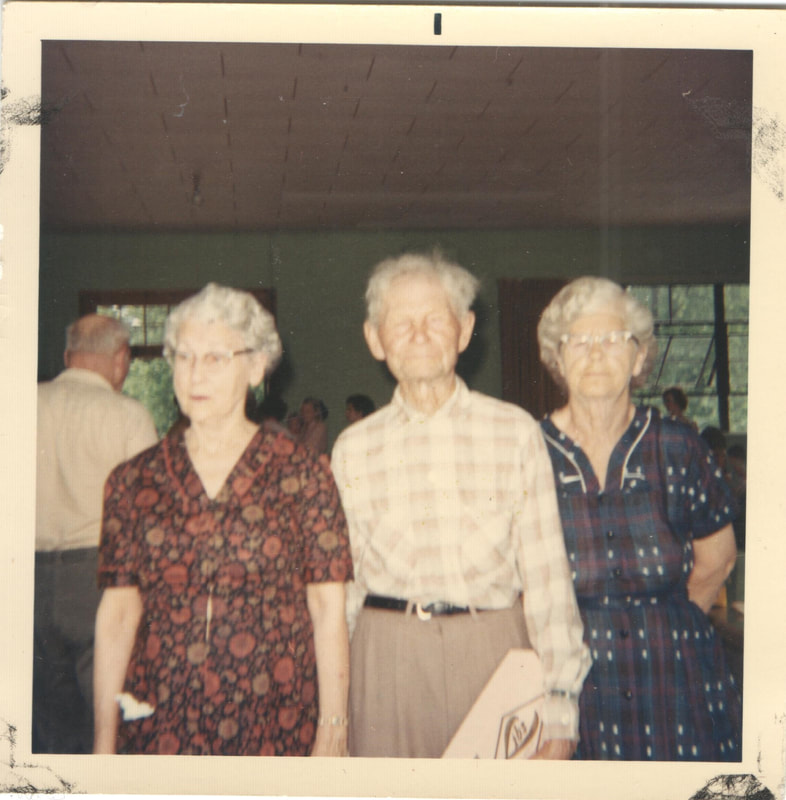 Elderly man and women standing together at family gathering