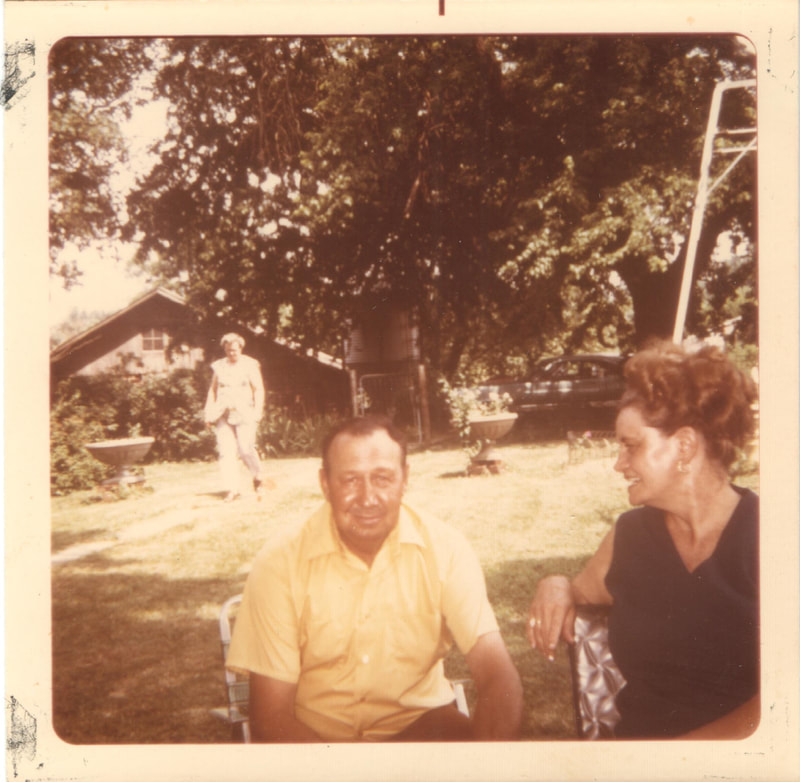 Man and woman seated together in back yard
