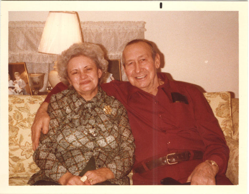 Elderly man and woman seated together on couch