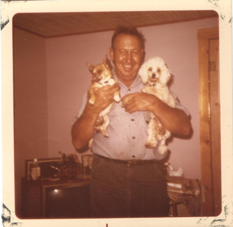 Elderly man holding small dogs