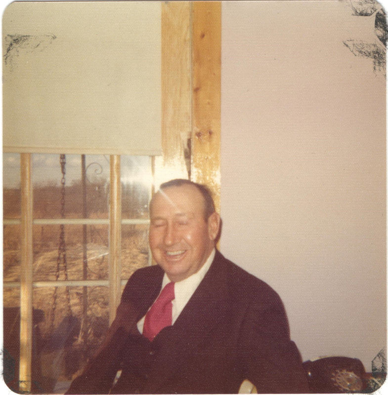 Elderly man in suit seated with eyes closed