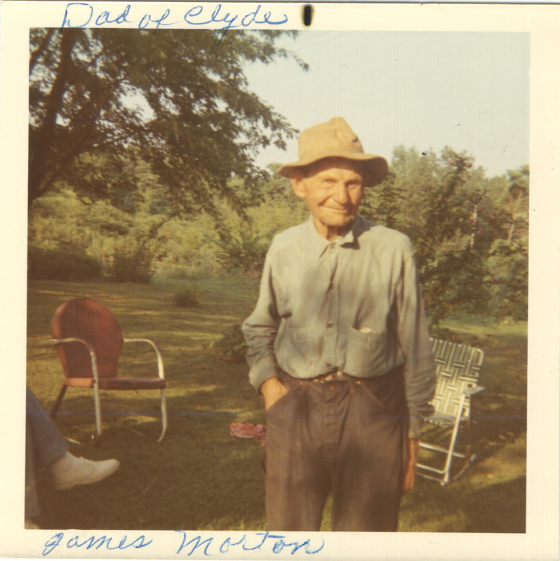 Elderly man in hat standing outdoors