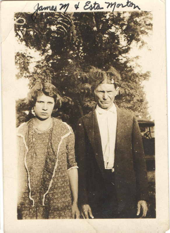 Man in suit standing next to woman in dress