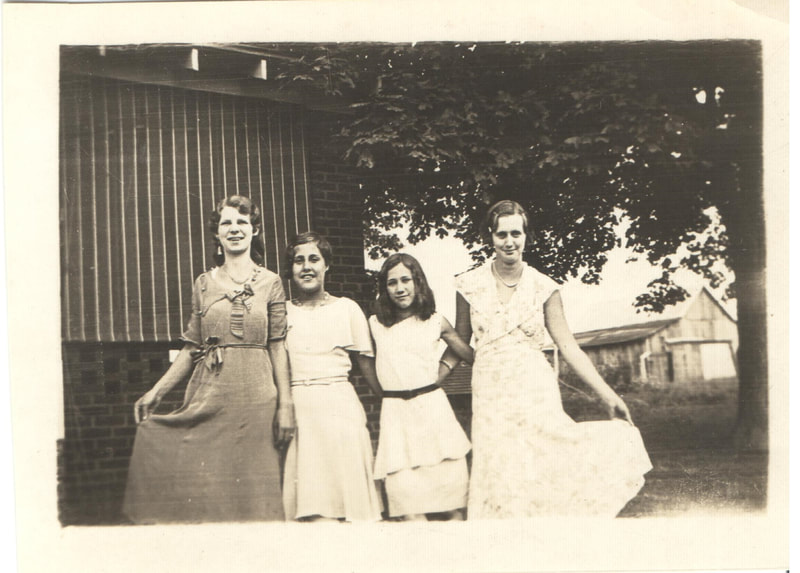 Young women standing together fanning dresses