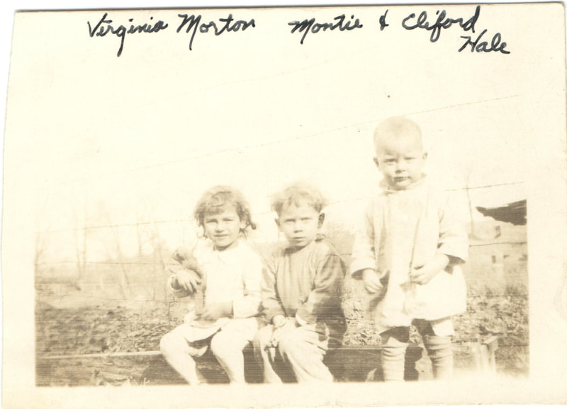 Young children seated together outdoors