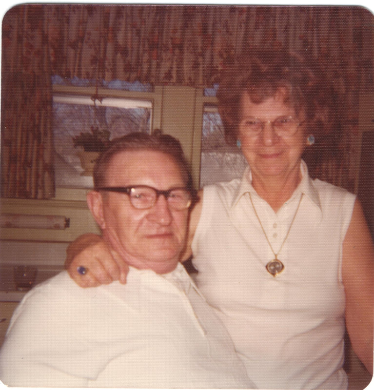 Man and woman in white shirts together inside of home