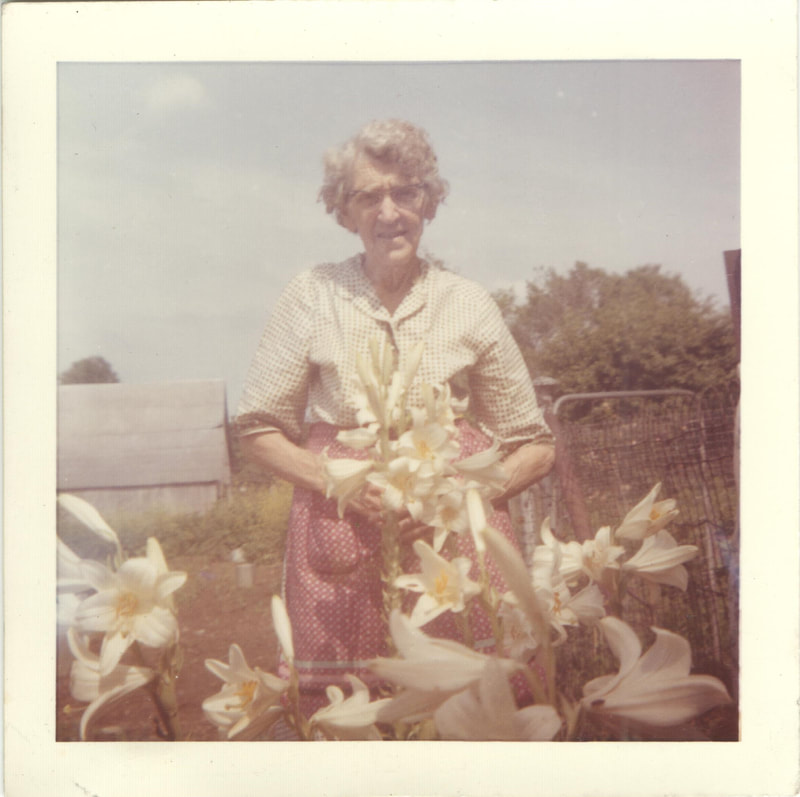 Elderly woman in flower garden