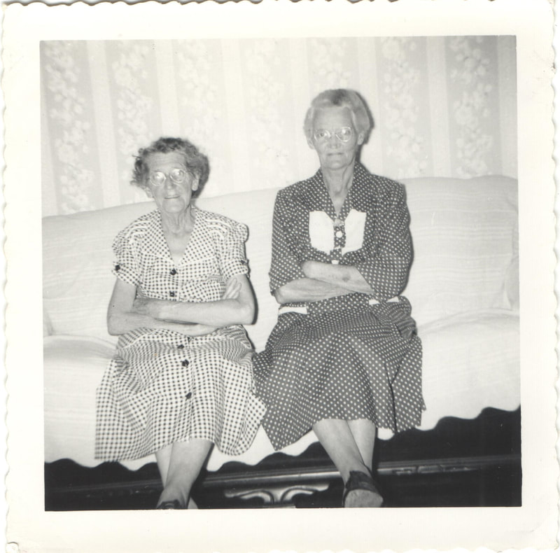 Elderly women seated together on couch