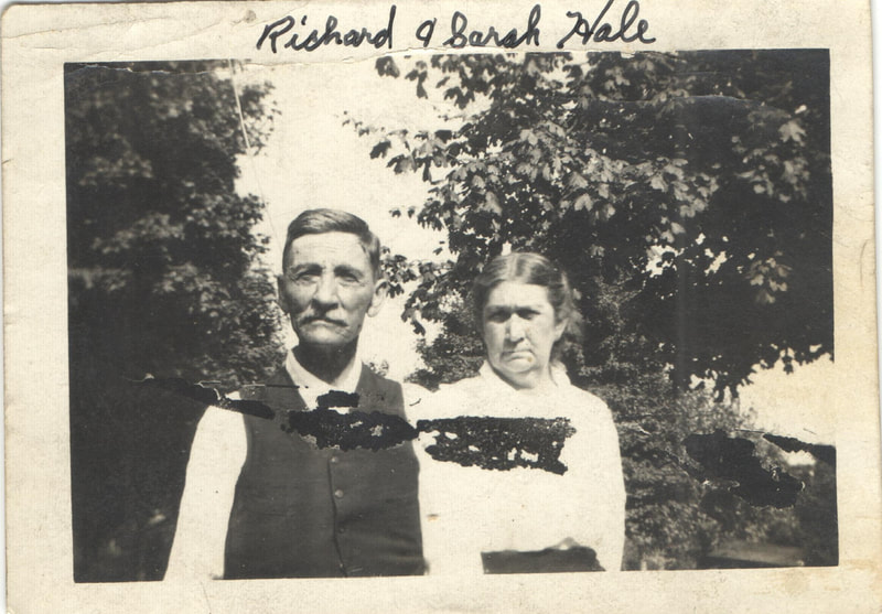 Elderly man and woman in formal dress standing together outdoors