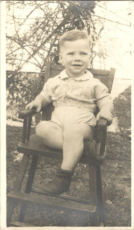 Young boy seated in chair