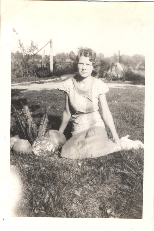 Young woman seated in yard