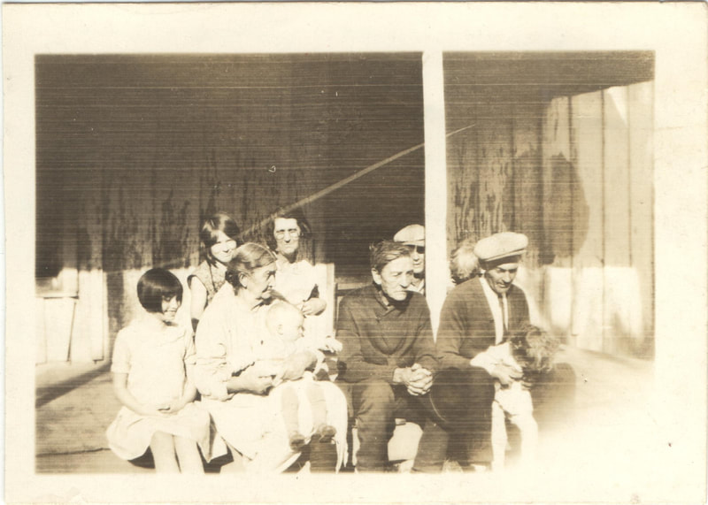 Family seated together on porch