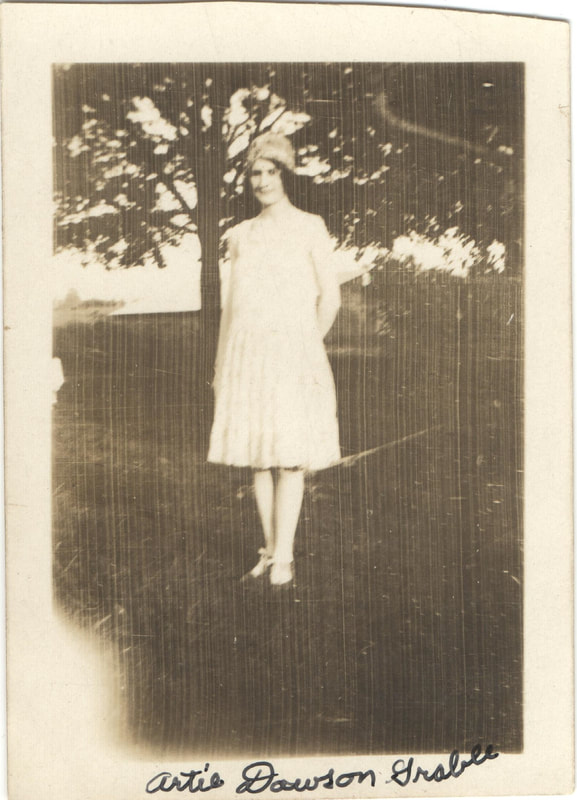 Young woman in hat standing outdoors