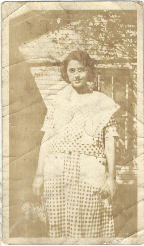 Young woman standing outside of home