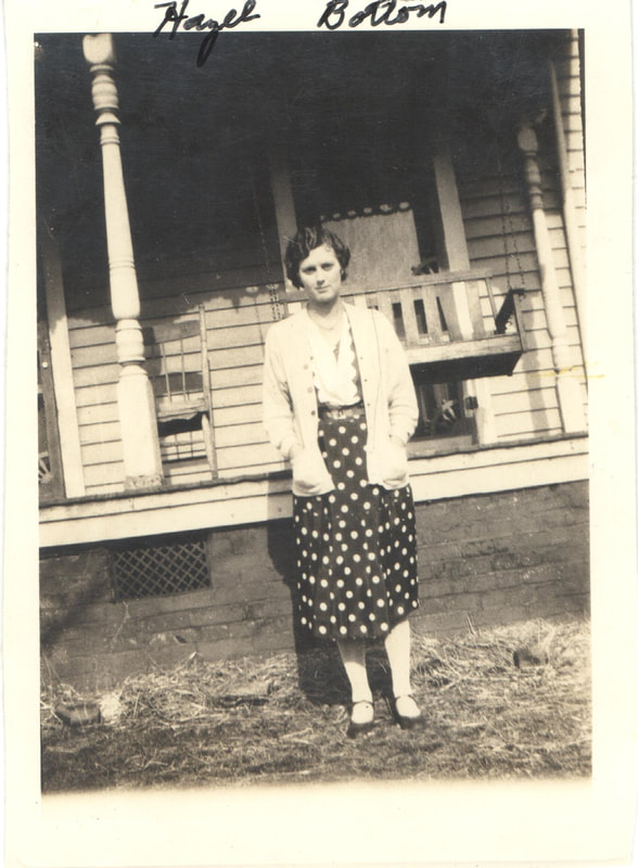 Young woman in polka dot dress in front of house