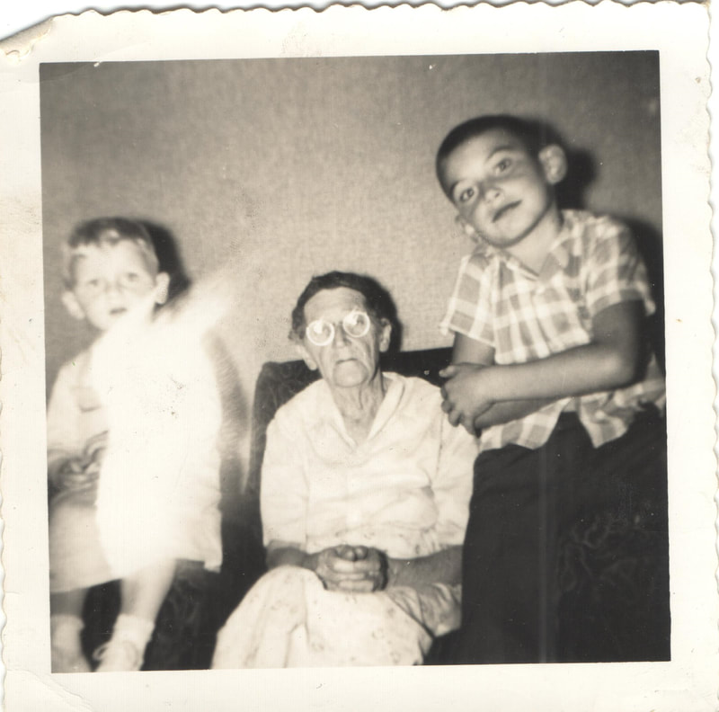 Elderly woman seated behind young boys