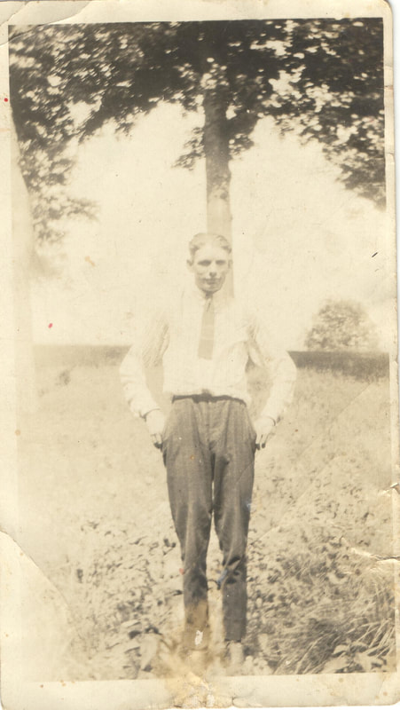 Young man in tie standing outdoors
