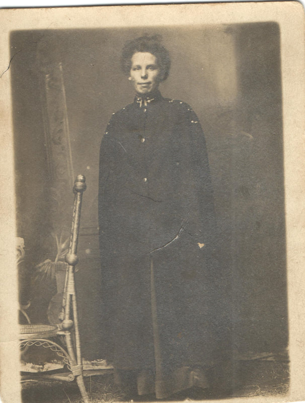 Woman standing in long overcoat