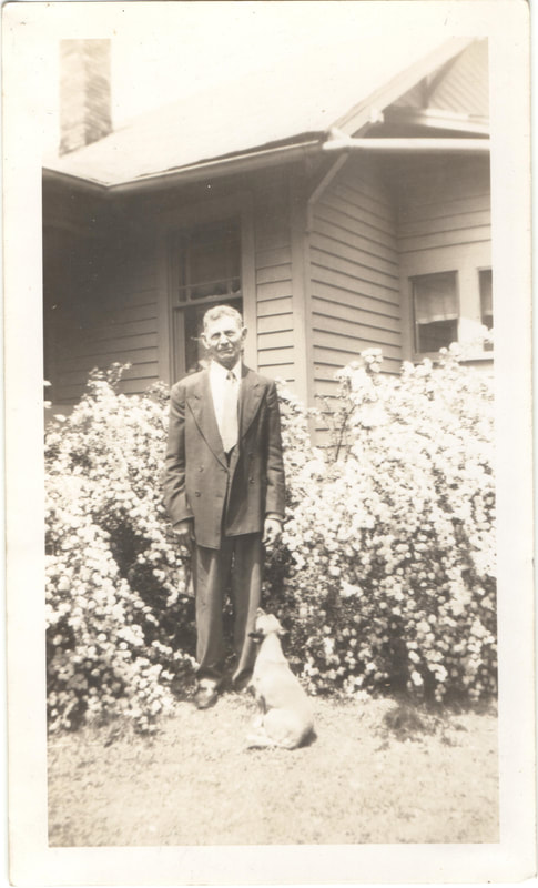 Man in suit standing next to dog
