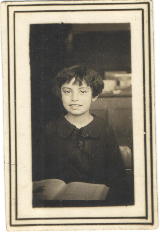 Young girl seated in front of book