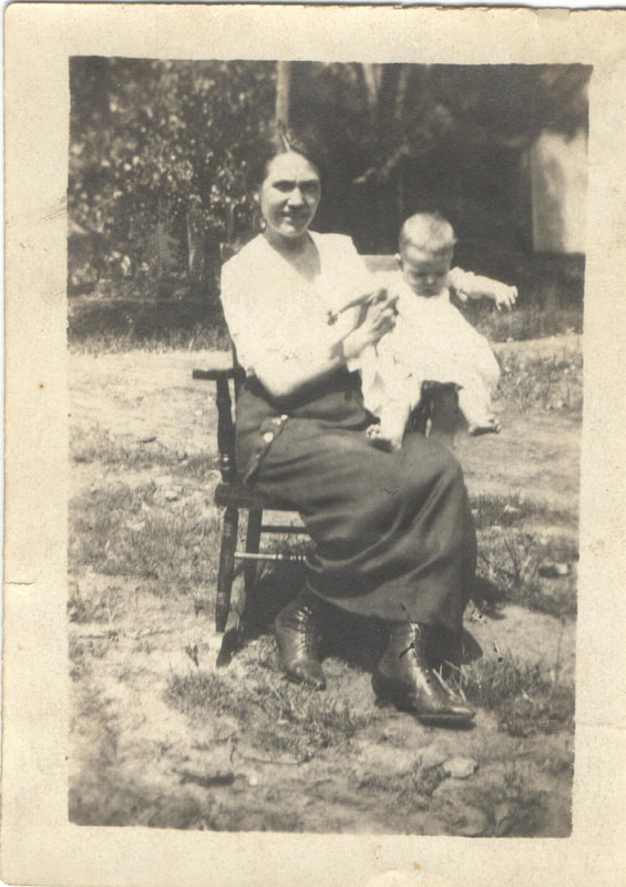 Woman seated with baby on chair outdoors