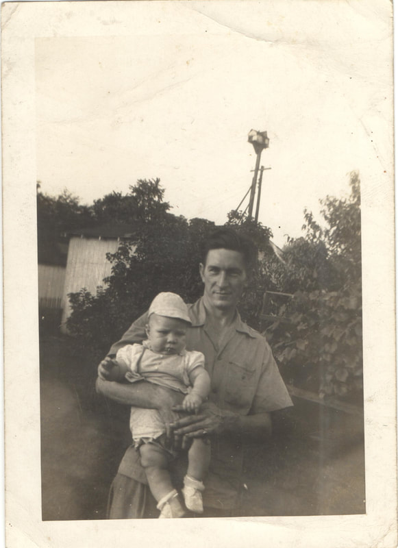 Man holding baby wearing hat